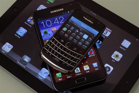 (From top to bottom) A Blackberry Bold smartphone, a Samsung Galaxy Note phablet, and an Apple iPad 2 tablet are displayed in this illustrat (From top to bottom) A Blackberry Bold smartphone, a Samsung Galaxy Note phablet, and an Apple iPad 2 tablet are displayed in this illustrat