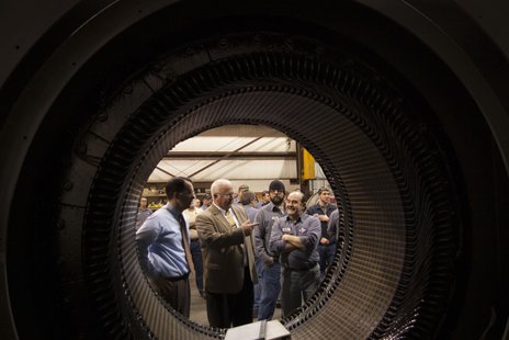 L&S Electric Vice President Paul Gulllickson with Governor Scott Walker as they look at a 6,000 horsepower electric motor that is being reconditioned for a Hibbing Minnesota mine. The picture is taken through the unfinished motor. L&S Electric Vice President Paul Gulllickson with Governor Scott Walker as they look at a 6,000 horsepower electric motor that is being reconditioned for a Hibbing Minnesota mine. The picture is taken through the unfinished motor.