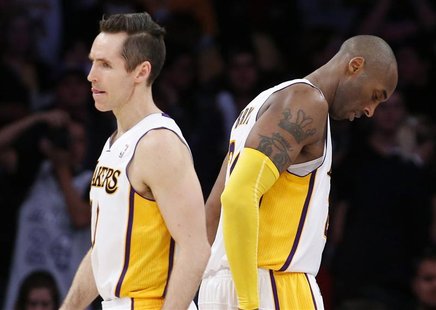 Los Angeles Lakers' Steve Nash (L) and Kobe Bryant walk on the court during the final minute of their loss to the Denver Nuggets during an N Los Angeles Lakers' Steve Nash (L) and Kobe Bryant walk on the court during the final minute of their loss to the Denver Nuggets during an N