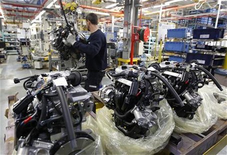 An employee at the Smart Cars factory is seen surrounded by engines as he works on the Smart Fortwo assembly line in Hambach, eastern France An employee at the Smart Cars factory is seen surrounded by engines as he works on the Smart Fortwo assembly line in Hambach, eastern France