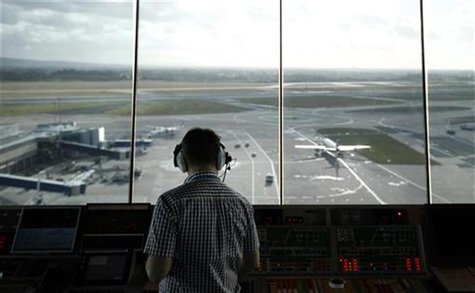 An air traffic controller monitors aircraft movement from the control tower at Manchester Airport, northern England, February 3, 2011. REUTE An air traffic controller monitors aircraft movement from the control tower at Manchester Airport, northern England, February 3, 2011. REUTE