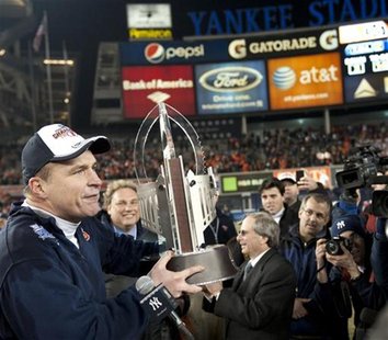 Syracuse University head coach Doug Marrone holds the championship trophy after they beat Kansas State University in their NCAA football Pin Syracuse University head coach Doug Marrone holds the championship trophy after they beat Kansas State University in their NCAA football Pin