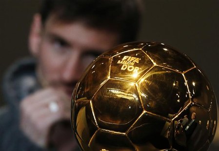 FIFA Men's Ballon d'Or of the Year 2012 nominee Lionel Messi of Argentina watches the trophy during a news conference before the FIFA Ballon FIFA Men's Ballon d'Or of the Year 2012 nominee Lionel Messi of Argentina watches the trophy during a news conference before the FIFA Ballon