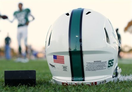 A football helmet's health warning sticker is pictured as the Oceanside Pirates high school football team prepares for their Friday night ga A football helmet's health warning sticker is pictured as the Oceanside Pirates high school football team prepares for their Friday night ga