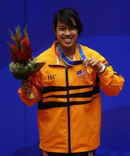Nicol Ann David of Malaysia holds her gold medal after winning the women's single squash final at the 16th Asian Games in Guangzhou, Guangdo Nicol Ann David of Malaysia holds her gold medal after winning the women's single squash final at the 16th Asian Games in Guangzhou, Guangdo
