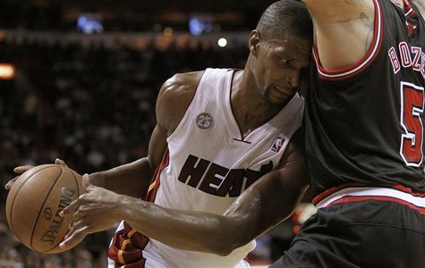 Miami Heat's Chris Bosh (L) collides with Chicago Bulls' Carlos Boozer (R) in the first half of their NBA basketball game in Miami, Florida Miami Heat's Chris Bosh (L) collides with Chicago Bulls' Carlos Boozer (R) in the first half of their NBA basketball game in Miami, Florida