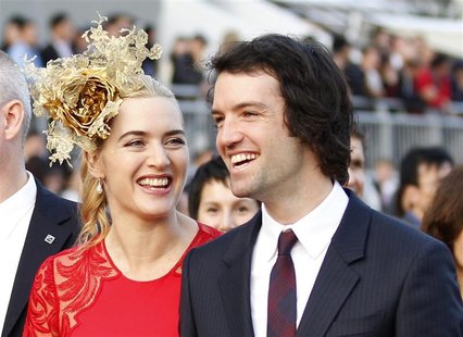 British actress Kate Winslet (L) and her husband Ned Rocknroll attend a promotional event for the Hong Kong international races in Hong Kong British actress Kate Winslet (L) and her husband Ned Rocknroll attend a promotional event for the Hong Kong international races in Hong Kong