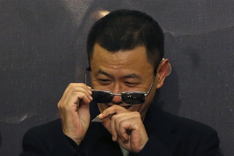 Hong Kong director Wong Kar-Wai removes confetti from his sunglasses after he beats a drum with cast members at the premiere of the movie "T Hong Kong director Wong Kar-Wai removes confetti from his sunglasses after he beats a drum with cast members at the premiere of the movie "T