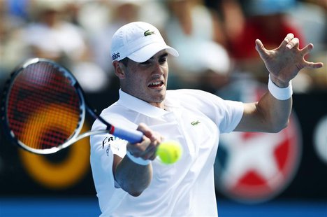 John Isner of U.S. hits a return to compatriot Ryan Harrison during their men's singles match at the Sydney International tennis tournament John Isner of U.S. hits a return to compatriot Ryan Harrison during their men's singles match at the Sydney International tennis tournament