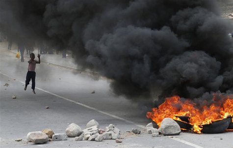 A child runs towards a burning barricade during a strike by farm workers at De Doorns on the N1 highway, linking Cape Town and Johannesburg, A child runs towards a burning barricade during a strike by farm workers at De Doorns on the N1 highway, linking Cape Town and Johannesburg,