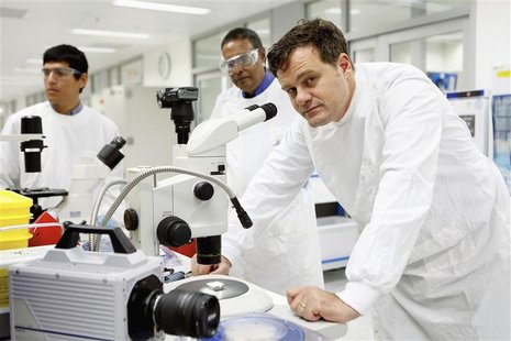Biomedical engineer Mark Kendall (R) poses beside a stereo microscope in a laboratory in Brisbane in this handout photograph taken in 2012. Biomedical engineer Mark Kendall (R) poses beside a stereo microscope in a laboratory in Brisbane in this handout photograph taken in 2012.