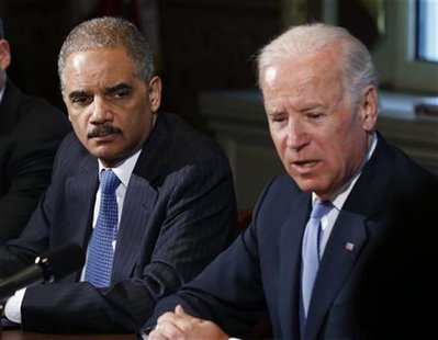 U.S. Attorney General Eric Holder (L) listens to U.S. Vice President Joe Biden speak to representatives of gun safety and gun violence victi U.S. Attorney General Eric Holder (L) listens to U.S. Vice President Joe Biden speak to representatives of gun safety and gun violence victi