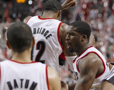 Portland Trail Blazers shooting guard Wesley Matthews (R) celebrates with teammates LaMarcus Aldridge (12) and Nicolas Batum (88) after defe Portland Trail Blazers shooting guard Wesley Matthews (R) celebrates with teammates LaMarcus Aldridge (12) and Nicolas Batum (88) after defe