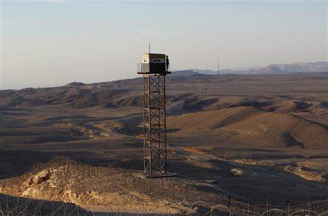 An Egyptian soldier stands guard on a watchtower on the border between Israel and Egypt, some 30 km (19 miles) north of Eilat, in this Novem An Egyptian soldier stands guard on a watchtower on the border between Israel and Egypt, some 30 km (19 miles) north of Eilat, in this Novem