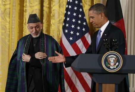 U.S. President Barack Obama (R) welcomes Afghan President Hamid Karzai prior to a joint news conference in the East Room of the White House U.S. President Barack Obama (R) welcomes Afghan President Hamid Karzai prior to a joint news conference in the East Room of the White House