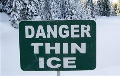 A thin ice warning sign. A thin ice warning sign.