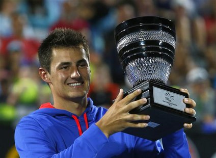 Bernard Tomic of Australia poses with the trophy after defeating Kevin Anderson of South Africa during their men's final match at the Sydney Bernard Tomic of Australia poses with the trophy after defeating Kevin Anderson of South Africa during their men's final match at the Sydney