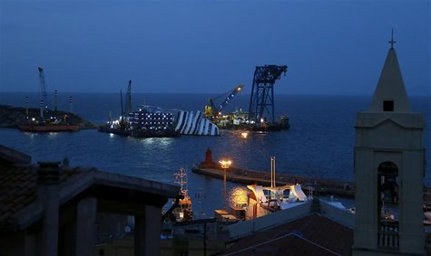 The capsized cruise liner Costa Concordia is pictured surrounded by cranes outside Giglio harbour January 12, 2013. REUTERS/Stefano Rellandi The capsized cruise liner Costa Concordia is pictured surrounded by cranes outside Giglio harbour January 12, 2013. REUTERS/Stefano Rellandi