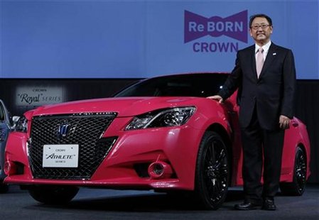 Toyota Motor Corp President Akio Toyoda poses next to the company's remodeled "Crown Athlete" at an unveiling in Tokyo December 25, 2012. RE Toyota Motor Corp President Akio Toyoda poses next to the company's remodeled "Crown Athlete" at an unveiling in Tokyo December 25, 2012. RE