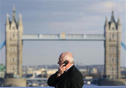 A man talks on a mobile telephone in front of Tower Bridge whilst walking across London Bridge in London March 1, 2010. REUTERS/Luke MacGreg A man talks on a mobile telephone in front of Tower Bridge whilst walking across London Bridge in London March 1, 2010. REUTERS/Luke MacGreg