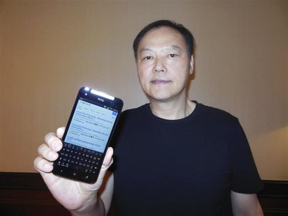 Peter Chou holds one of his devices sporting a new Myanmar font ahead of Monday's launch of the product in Yangon January 13, 2013. REUTERS/ Peter Chou holds one of his devices sporting a new Myanmar font ahead of Monday's launch of the product in Yangon January 13, 2013. REUTERS/