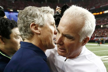 Atlanta Falcons head coach Mike Smith (R) speaks with Seattle Seahawks head coach Pete Carroll after the Falcons defeated the Seahawks in th Atlanta Falcons head coach Mike Smith (R) speaks with Seattle Seahawks head coach Pete Carroll after the Falcons defeated the Seahawks in th