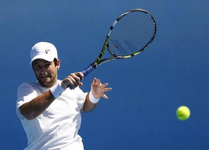 Brian Baker of the U.S. hits a return to Alex Bogomolov Jr. of Russia during their men's singles match at the Australian Open tennis tournam Brian Baker of the U.S. hits a return to Alex Bogomolov Jr. of Russia during their men's singles match at the Australian Open tennis tournam