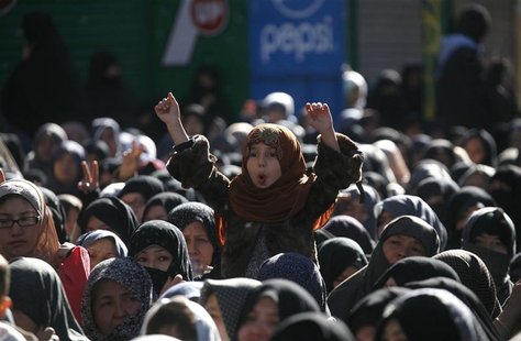 A girl from the Shi'ite Hazara community gestures as she attends a funeral ceremony of the victims who were killed three days ago by a bomb A girl from the Shi'ite Hazara community gestures as she attends a funeral ceremony of the victims who were killed three days ago by a bomb