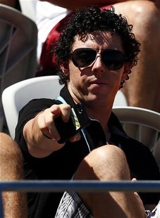 Irish golfer Rory McIlroy, currently ranked world number one, watches Denmark's Caroline Wozniacki during her first round match against Pola Irish golfer Rory McIlroy, currently ranked world number one, watches Denmark's Caroline Wozniacki during her first round match against Pola