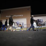 People push loaded shopping carts at a Walmart store, on Thanksgiving day in North Bergan, New Jersey November 22, 2012. REUTERS/Eric Thayer