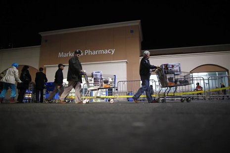 People push loaded shopping carts at a Walmart store, on Thanksgiving day in North Bergan, New Jersey November 22, 2012. REUTERS/Eric Thayer People push loaded shopping carts at a Walmart store, on Thanksgiving day in North Bergan, New Jersey November 22, 2012. REUTERS/Eric Thayer