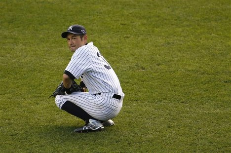 New York Yankees left fielder Ichiro Suzuki pauses during a break in play against the Detroit Tigers in the seventh inning of Game 2 of thei New York Yankees left fielder Ichiro Suzuki pauses during a break in play against the Detroit Tigers in the seventh inning of Game 2 of thei