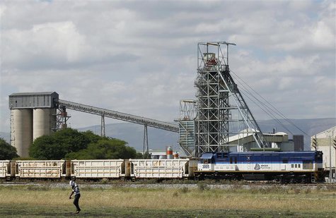 A man walks past a train carrying goods, at Anglo Platinum's Khomanani shaft 1 mine in Rustenburg, northwest of Johannesburg January 15, 201 A man walks past a train carrying goods, at Anglo Platinum's Khomanani shaft 1 mine in Rustenburg, northwest of Johannesburg January 15, 201