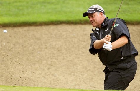 Darren Clarke of Northern Ireland hits out of the bunker onto the 9th green during the first round of the European Masters golf tournament i Darren Clarke of Northern Ireland hits out of the bunker onto the 9th green during the first round of the European Masters golf tournament i