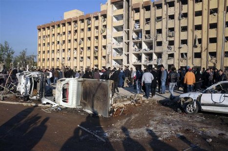 Syrian security personnel and civilians gather at the site where two explosions rocked the University of Aleppo in Syria's second largest ci Syrian security personnel and civilians gather at the site where two explosions rocked the University of Aleppo in Syria's second largest ci