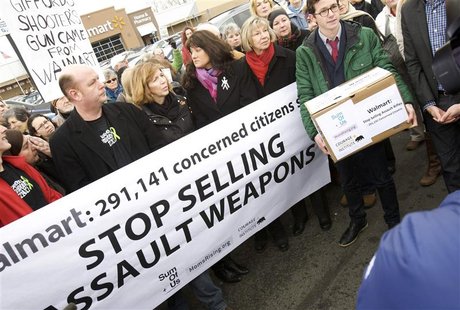 Protesters, including (front row L -R)Darren Wagner, Lori Haas, Roxanna Green and Pam Simon, gather to deliver a petition to Walmart during Protesters, including (front row L -R)Darren Wagner, Lori Haas, Roxanna Green and Pam Simon, gather to deliver a petition to Walmart during