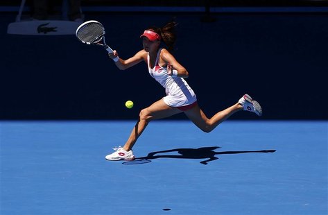 Agnieszka Radwanska of Poland hits a return to Irina-Camelia Begu of Romania during their women's singles match at the Australian Open tenni Agnieszka Radwanska of Poland hits a return to Irina-Camelia Begu of Romania during their women's singles match at the Australian Open tenni