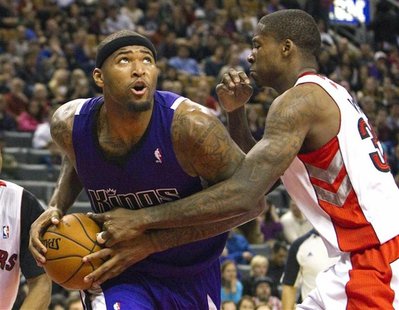 Sacramento Kings' DeMarcus Cousins drives to the basket past Toronto Raptors' Ed Davis (R) in the second half of their NBA basketball game i Sacramento Kings' DeMarcus Cousins drives to the basket past Toronto Raptors' Ed Davis (R) in the second half of their NBA basketball game i