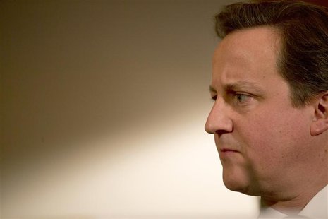 Britain's Prime Minister, David Cameron, listens to Deputy Prime Minister, Nick Clegg (UNSEEN), at a news conference in 10 Downing Street in Britain's Prime Minister, David Cameron, listens to Deputy Prime Minister, Nick Clegg (UNSEEN), at a news conference in 10 Downing Street in