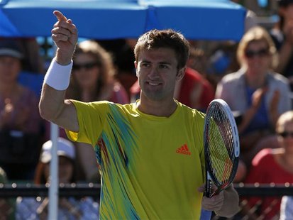 Tim Smyczek of the U.S. celebrates defeating Ivo Karlovic of Croatia in their men's singles match at the Australian Open tennis tournament i Tim Smyczek of the U.S. celebrates defeating Ivo Karlovic of Croatia in their men's singles match at the Australian Open tennis tournament i
