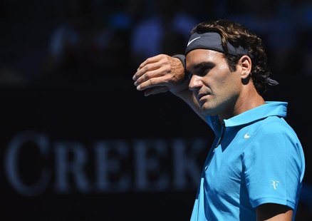 Roger Federer of Switzerland wipes his brow during his men's singles match against Benoit Paire of France at the Australian Open tennis tour Roger Federer of Switzerland wipes his brow during his men's singles match against Benoit Paire of France at the Australian Open tennis tour