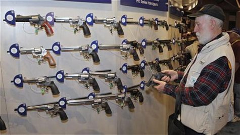 Homer Van Meter, of Rhineland, WI, inspects a revolver during the National Rifle Association's (NRA) 141st Annual Meetings & Exhibits in St. Homer Van Meter, of Rhineland, WI, inspects a revolver during the National Rifle Association's (NRA) 141st Annual Meetings & Exhibits in St.