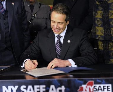 New York Governor Andrew Cuomo signs the New York Secure Ammunition and Firearms Enforcement Act at the Capitol in Albany, New York January New York Governor Andrew Cuomo signs the New York Secure Ammunition and Firearms Enforcement Act at the Capitol in Albany, New York January