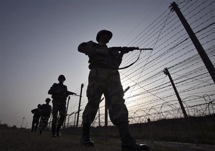 Indian Border Security Force (BSF) soldiers patrol the fenced border with Pakistan in Suchetgarh, southwest of Jammu January 16, 2013. Two P Indian Border Security Force (BSF) soldiers patrol the fenced border with Pakistan in Suchetgarh, southwest of Jammu January 16, 2013. Two P