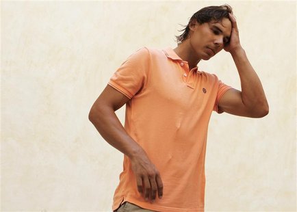 Spain's Rafael Nadal combs his hair back with his hand between television interviews, during which he detailed reasons for pulling out of th Spain's Rafael Nadal combs his hair back with his hand between television interviews, during which he detailed reasons for pulling out of th
