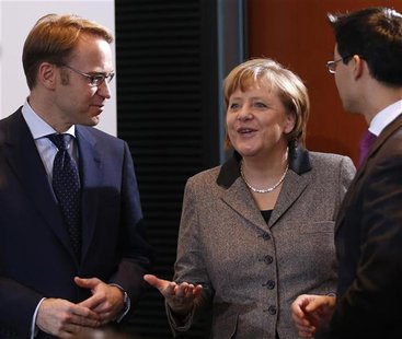 German Chancellor Angela Merkel (C) and Economy Minister Philipp Roesler (R) chat with President of German Bundesbank Jens Weidmann before t German Chancellor Angela Merkel (C) and Economy Minister Philipp Roesler (R) chat with President of German Bundesbank Jens Weidmann before t