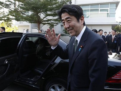 Japan's Prime Minister Shinzo Abe waves before he leaves the Thai-Nichi Institute of Technology in Bangkok January 17, 2013. Abe is on a one Japan's Prime Minister Shinzo Abe waves before he leaves the Thai-Nichi Institute of Technology in Bangkok January 17, 2013. Abe is on a one
