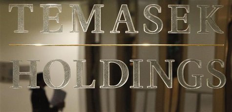 A staff member is reflected in a Temasek Holdings logo at their headquarters before the presentation of Temasek's annual review in Singapore A staff member is reflected in a Temasek Holdings logo at their headquarters before the presentation of Temasek's annual review in Singapore