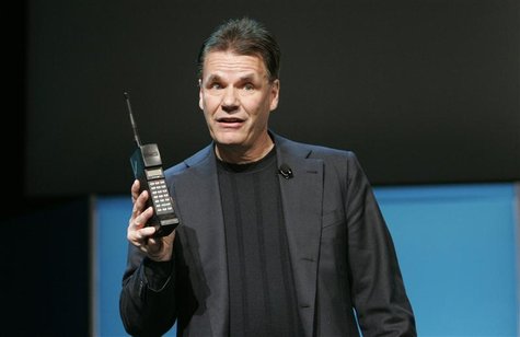 Former Nokia President and Chief Executive Olli-Pekka Kallasvuo holds a Nokia mobile phone from 1987 during his keynote speech at the 2010 I Former Nokia President and Chief Executive Olli-Pekka Kallasvuo holds a Nokia mobile phone from 1987 during his keynote speech at the 2010 I