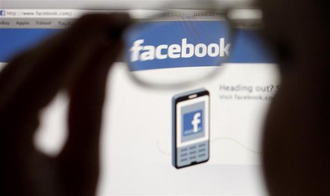 In this photo illustration, a Facebook logo on a computer screen is seen through glasses held by a woman in Bern May 19, 2012. Picture taken In this photo illustration, a Facebook logo on a computer screen is seen through glasses held by a woman in Bern May 19, 2012. Picture taken